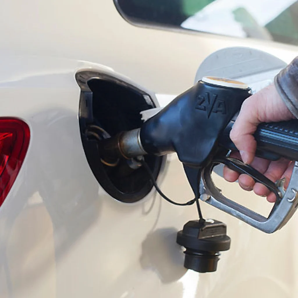 a person holding a gas pump