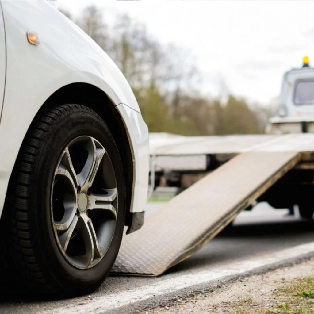 a car with a flatbed truck