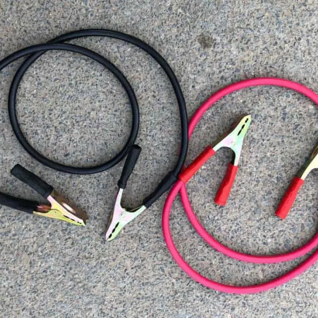 a group of car jump start cables on the ground