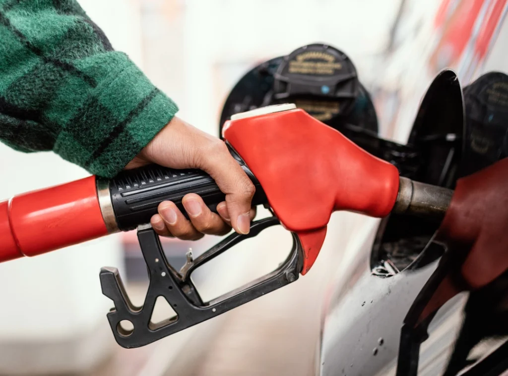 a person holding a gas pump