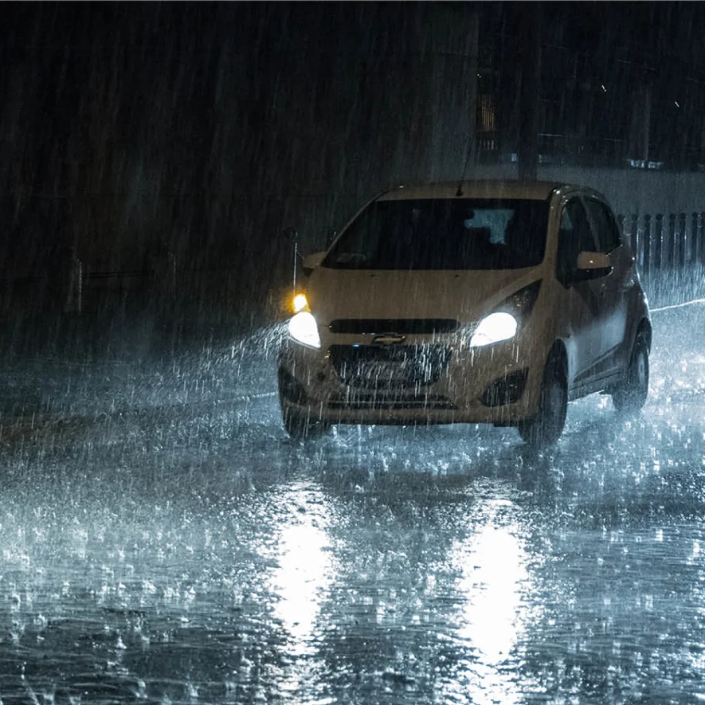 a car driving through the rain