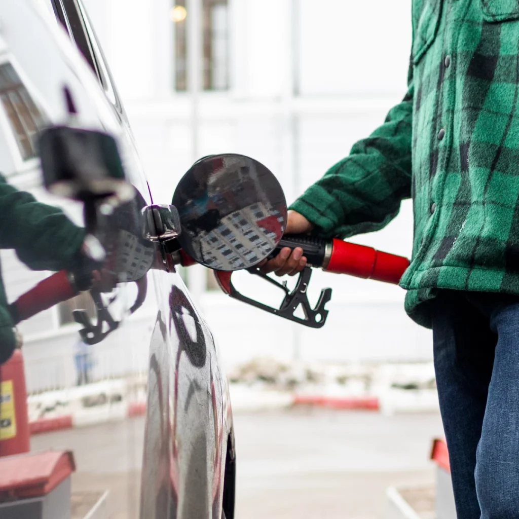 a person holding a gas pump