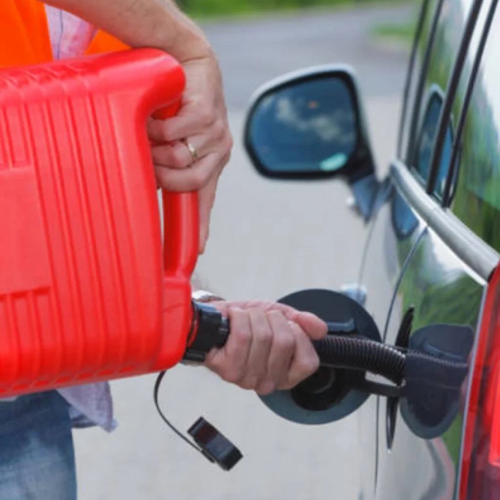 a person filling up a gas tank