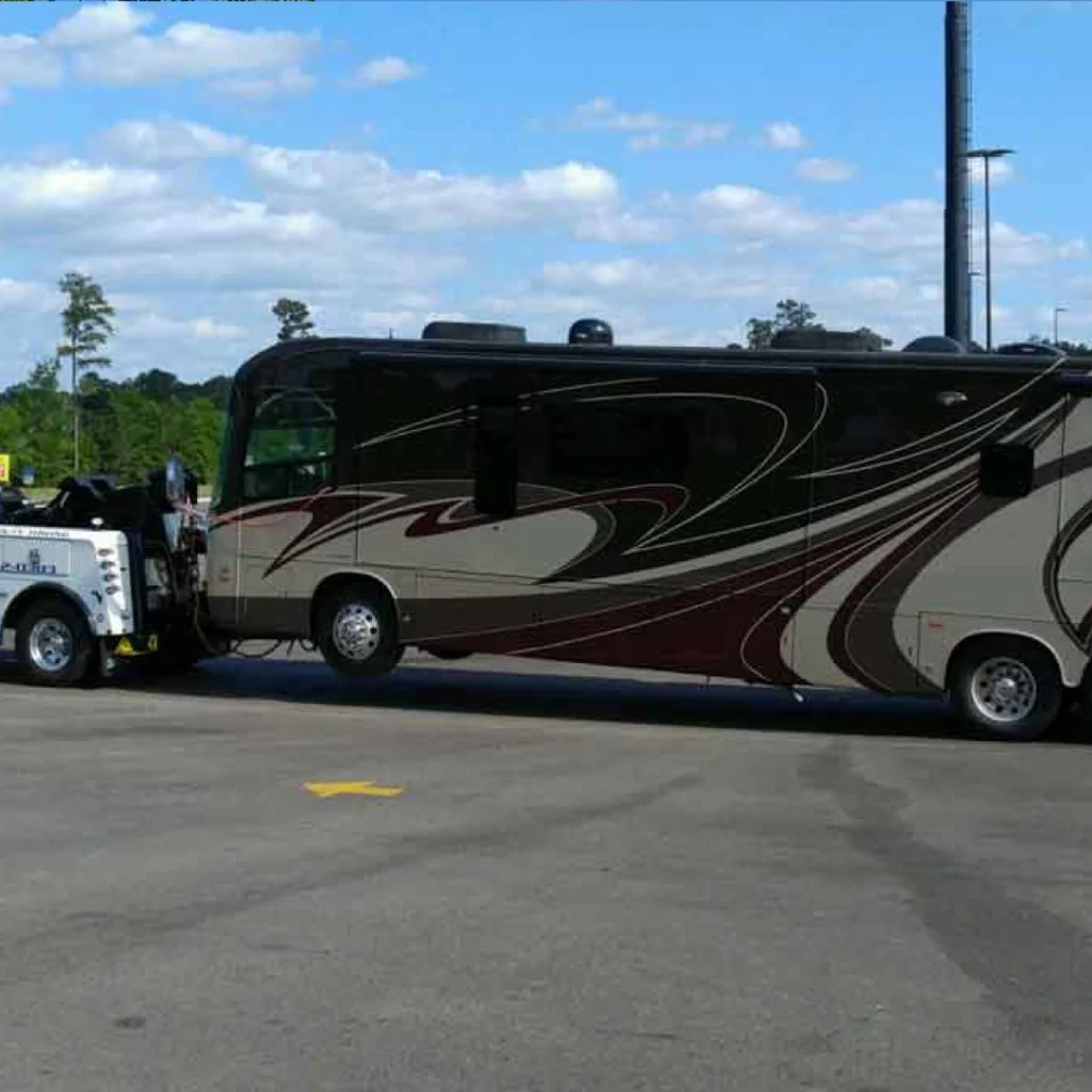 a large rv towing by a tow truck