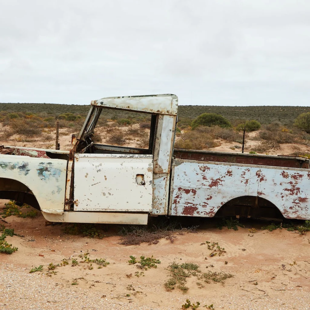 a rusty old truck in the desert